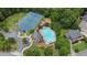 An aerial view featuring community amenities including a pool, clubhouse, and tennis courts nestled in a wooded setting at 1342 Winborn Nw Cir, Kennesaw, GA 30152