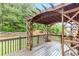 A well-maintained back deck with a custom pergola offers a cozy outdoor space with backyard views at 1342 Winborn Nw Cir, Kennesaw, GA 30152
