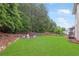 A sprawling backyard features a manicured lawn and serene wooded backdrop for outdoor enjoyment and privacy at 1342 Winborn Nw Cir, Kennesaw, GA 30152