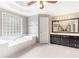 Bright bathroom featuring a large soaking tub, and a vanity with dark wood cabinets and a large mirror at 1342 Winborn Nw Cir, Kennesaw, GA 30152