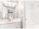 Clean, white bathroom with a large vanity mirror, tub-shower combo, and bright lighting at 1342 Winborn Nw Cir, Kennesaw, GA 30152