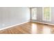 Empty room with hardwood flooring, two windows, and neutral-colored walls at 1342 Winborn Nw Cir, Kennesaw, GA 30152