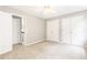 This is a bedroom with carpet and a ceiling fan and white closet doors at 1342 Winborn Nw Cir, Kennesaw, GA 30152
