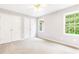 This is a bedroom with a ceiling fan and large windows with green foliage outside at 1342 Winborn Nw Cir, Kennesaw, GA 30152