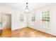 Bright dining room with hardwood floors, classic chandelier, and large windows overlooking the backyard at 1342 Winborn Nw Cir, Kennesaw, GA 30152