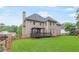 A charming home exterior view featuring a well-kept lawn, mature trees, and detailed architectural design at 1342 Winborn Nw Cir, Kennesaw, GA 30152