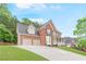 Brick home with two-car garage and well-maintained lawn on a sunny day at 1342 Winborn Nw Cir, Kennesaw, GA 30152