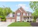 Traditional two-story brick home with a landscaped front yard and covered porch at 1342 Winborn Nw Cir, Kennesaw, GA 30152