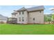 Rear exterior view showcasing a spacious backyard, deck with pergola, and well-maintained siding at 1342 Winborn Nw Cir, Kennesaw, GA 30152