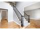 Entryway featuring hardwood floors, staircase with black railings, and neutral paint at 1342 Winborn Nw Cir, Kennesaw, GA 30152