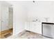 A kitchenette with white cabinets and a mini fridge and slate tile flooring at 1342 Winborn Nw Cir, Kennesaw, GA 30152