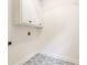 Well-lit laundry room with cabinet storage and designer tile flooring at 1342 Winborn Nw Cir, Kennesaw, GA 30152