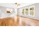Bright living room seamlessly connects to the kitchen with large windows and hardwood floors at 1342 Winborn Nw Cir, Kennesaw, GA 30152