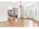 Bright living room features hardwood floors, elegant chandelier, and wainscoting details at 1342 Winborn Nw Cir, Kennesaw, GA 30152