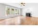 Spacious living room with a cozy fireplace and large windows overlooking the backyard at 1342 Winborn Nw Cir, Kennesaw, GA 30152