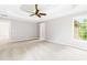 Generous main bedroom with a tray ceiling, plush carpet, and views of the backyard at 1342 Winborn Nw Cir, Kennesaw, GA 30152