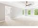 Spacious main bedroom with tray ceiling, neutral carpet, and ample natural light from large windows at 1342 Winborn Nw Cir, Kennesaw, GA 30152