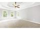 Large main bedroom showcasing a tray ceiling and three bright windows at 1342 Winborn Nw Cir, Kennesaw, GA 30152