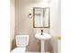Charming powder room featuring a pedestal sink and decorative mirror at 1342 Winborn Nw Cir, Kennesaw, GA 30152