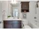 Bathroom featuring dark wood vanity, white tiled walls, showerhead, and modern fixtures at 1365 Memorial Se Dr # 8, Atlanta, GA 30317