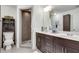 Modern bathroom featuring double vanity, framed mirror, and tiled shower stall with glass door at 1365 Memorial Se Dr # 8, Atlanta, GA 30317