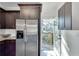 Kitchen with stainless steel refrigerator and access to the outdoor balcony through a glass door at 1365 Memorial Se Dr # 8, Atlanta, GA 30317