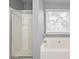 Clean bathroom featuring a bathtub and shower combination with bright, natural light at 2727 Northgate Nw Way, Acworth, GA 30101