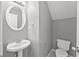 Stylish powder room with modern fixtures, vessel sink, and a round mirror at 2727 Northgate Nw Way, Acworth, GA 30101
