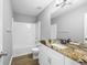 Bathroom featuring a granite countertop vanity and shower-tub combo at 2727 Northgate Nw Way, Acworth, GA 30101