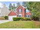Lovely two-story red brick home with mature landscaping and an attached two-car garage at 2727 Northgate Nw Way, Acworth, GA 30101
