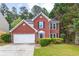 Charming red brick home with a well-manicured lawn and two-car garage, perfect for a Gathering at 2727 Northgate Nw Way, Acworth, GA 30101