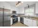 Modern kitchen with stainless steel appliances, granite countertops, and white cabinetry at 2727 Northgate Nw Way, Acworth, GA 30101