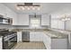 Well-equipped kitchen with granite countertops, white cabinetry, and stainless steel appliances at 2727 Northgate Nw Way, Acworth, GA 30101