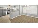 Bright kitchen and dining area with stainless steel appliances, breakfast bar and wood floors at 2727 Northgate Nw Way, Acworth, GA 30101