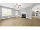 Open-concept living room with a fireplace, modern flooring, and seamless flow to the kitchen at 2727 Northgate Nw Way, Acworth, GA 30101