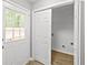 Convenient mud room with access to the outside and featuring a utility closet and door with a window at 2727 Northgate Nw Way, Acworth, GA 30101