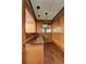 Quaint bar area featuring a sink, countertop, mirror, wood paneling, and stylish lighting at 3341 Rae Pl, Lawrenceville, GA 30044