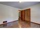 Bedroom with hardwood floors, closet, and a view into an adjacent room at 3341 Rae Pl, Lawrenceville, GA 30044