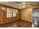 Bedroom displaying wood paneling, natural light from a window, and hardwood floors at 3341 Rae Pl, Lawrenceville, GA 30044