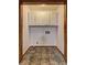 Small laundry room with white cabinets and tile floors at 3341 Rae Pl, Lawrenceville, GA 30044
