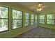 Bright sunroom with tile floors, multiple large windows, and a ceiling fan for added comfort at 3341 Rae Pl, Lawrenceville, GA 30044