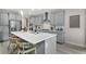 Modern kitchen with gray cabinets, stainless steel appliances, and a large island with seating at 5335 Trescott Path, Cumming, GA 30028