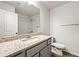 Clean bathroom with granite countertop, dual sinks, and tiled shower at 7492 Knoll Hollow Rd, Lithonia, GA 30058