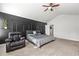 Spacious bedroom with modern black accent wall and stylish ceiling fan at 7492 Knoll Hollow Rd, Lithonia, GA 30058