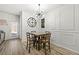 Stylish dining area features modern lighting, a wooden table with chairs, and decorative wall panels at 7492 Knoll Hollow Rd, Lithonia, GA 30058