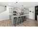 Modern eat-in kitchen features an island with stool seating, stainless appliances, and gray cabinetry at 7492 Knoll Hollow Rd, Lithonia, GA 30058