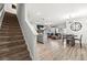 Bright, open living space with stairs, island, dining area, and living room, perfect for entertaining at 7492 Knoll Hollow Rd, Lithonia, GA 30058