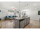 Open-concept living space features a kitchen island, dining area, and comfortable seating at 7492 Knoll Hollow Rd, Lithonia, GA 30058