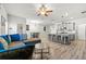 Open-concept living space featuring a kitchen island, dining area, and comfortable seating at 7492 Knoll Hollow Rd, Lithonia, GA 30058
