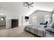 Serene main bedroom with a ceiling fan, plush carpet, and ample natural light at 7492 Knoll Hollow Rd, Lithonia, GA 30058